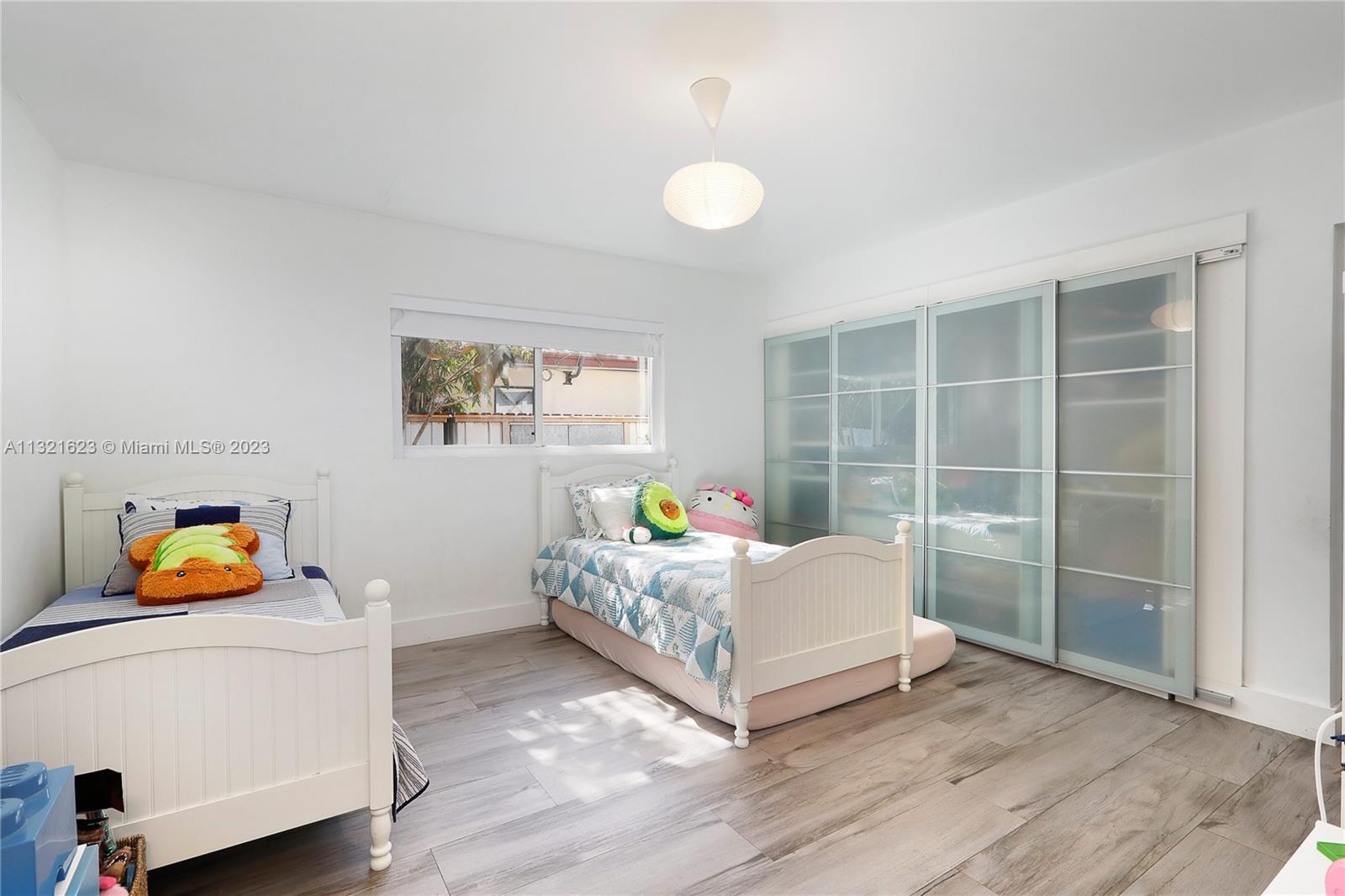 425 Glenridge Road Key Biscayne, FL 33149 - Photo 20 of 37 a bedroom with a bed and a window