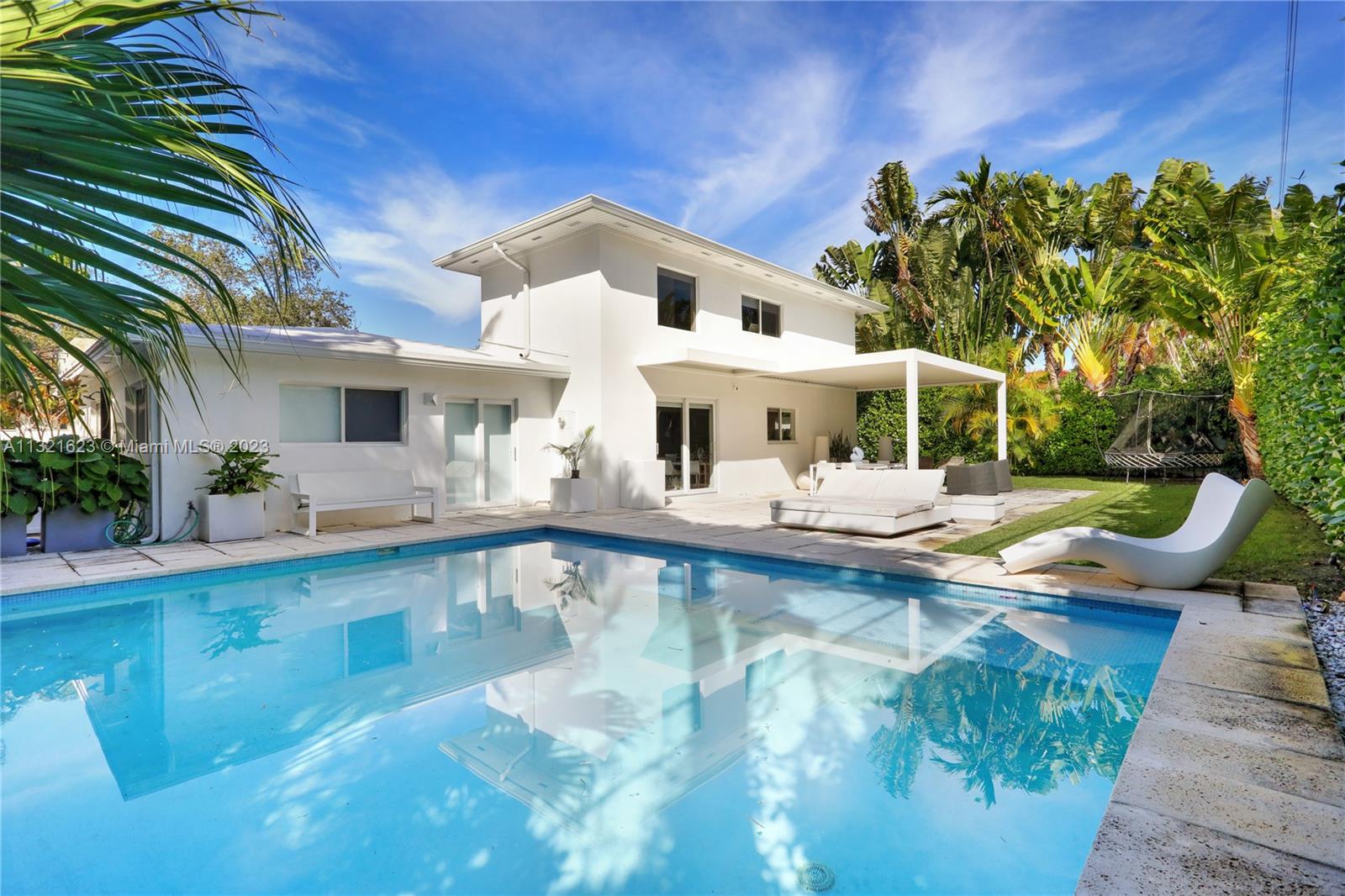 425 Glenridge Road Key Biscayne, FL 33149 - Photo 2 of 37 a view of a swimming pool with a patio