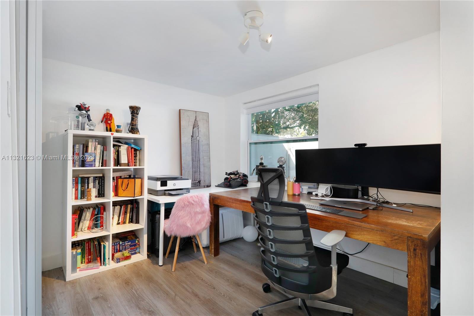 425 Glenridge Road Key Biscayne, FL 33149 - Photo 23 of 37 a view of a workspace with furniture and a bookshelf
