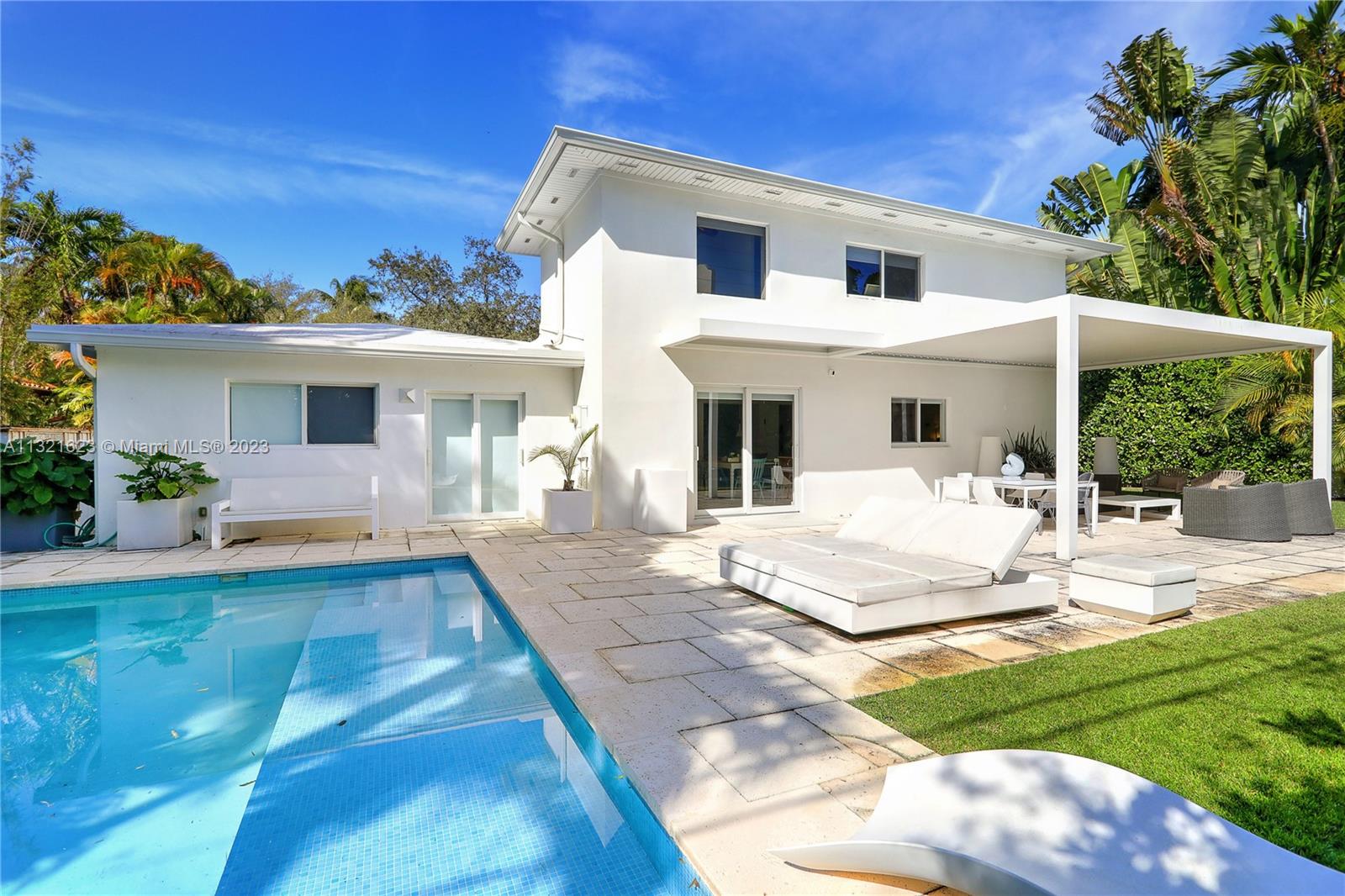 425 Glenridge Road Key Biscayne, FL 33149 - Photo 29 of 37 a front view of a house with a yard porch and furniture