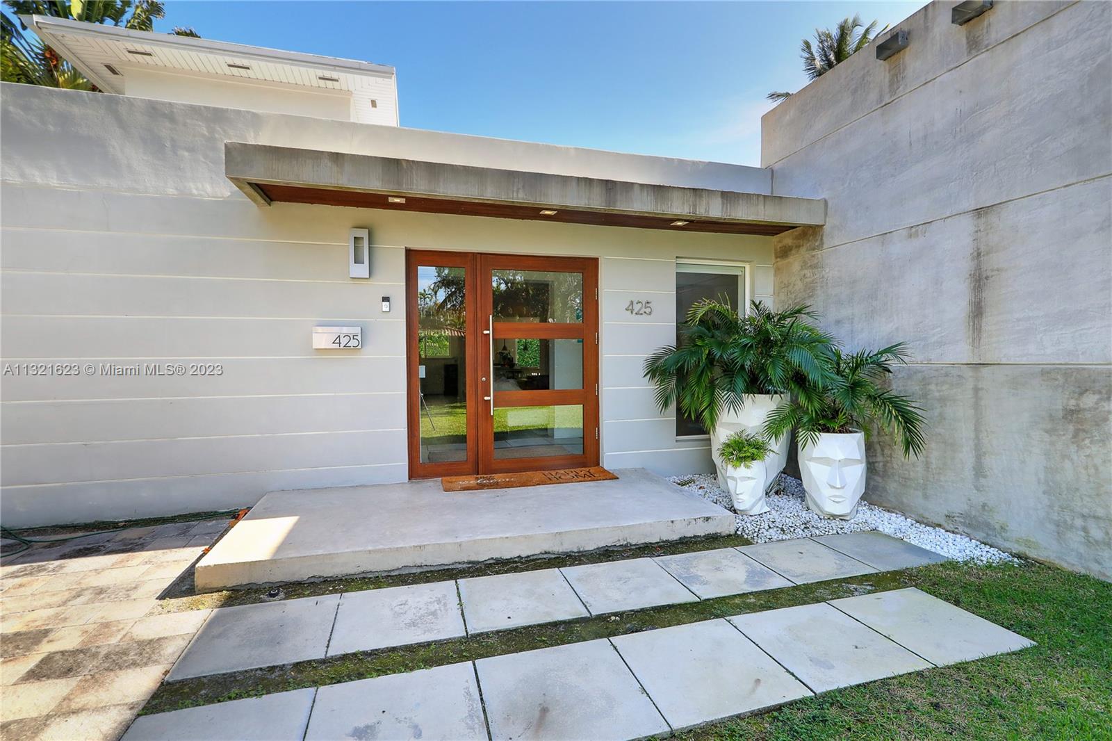425 Glenridge Road Key Biscayne, FL 33149 - Photo 3 of 37 a view of a house with a patio