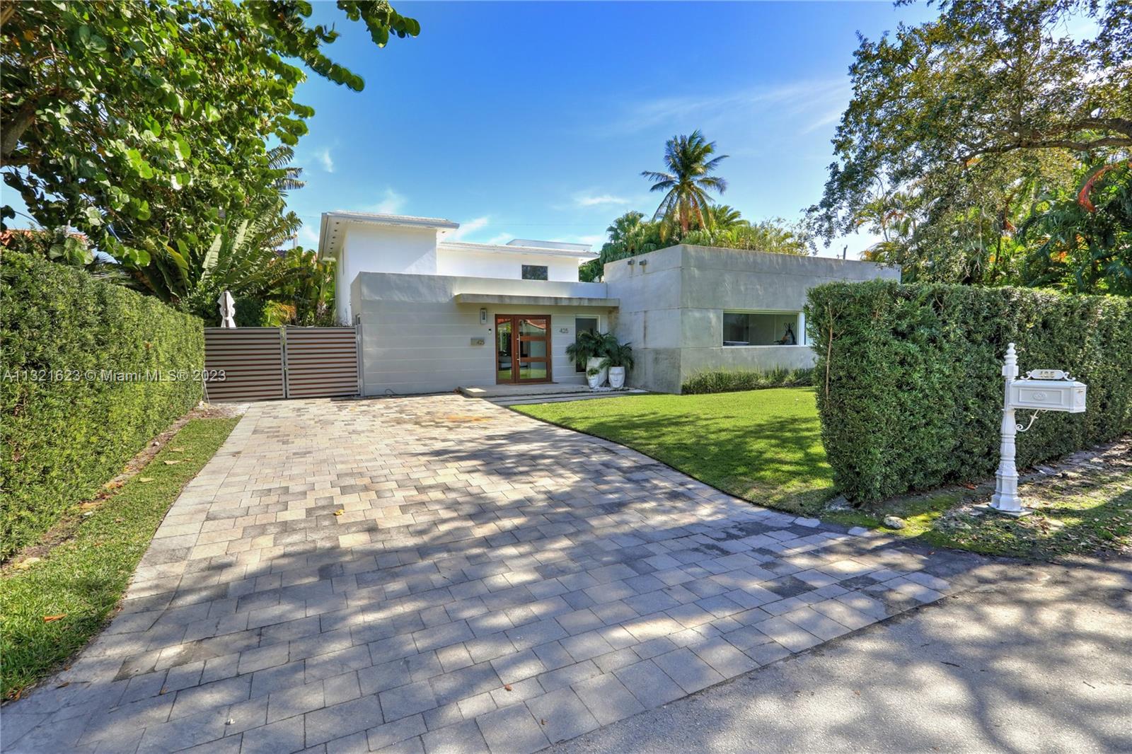 425 Glenridge Road Key Biscayne, FL 33149 - Photo 35 of 37 a front view of a house with garden