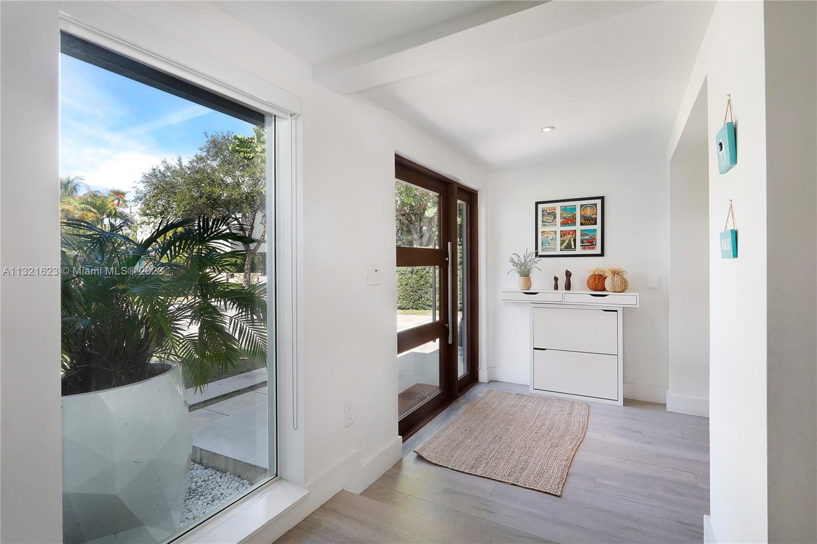 425 Glenridge Road Key Biscayne, FL 33149 - Photo 4 of 37 a view of a hallway with a large window and kitchen view