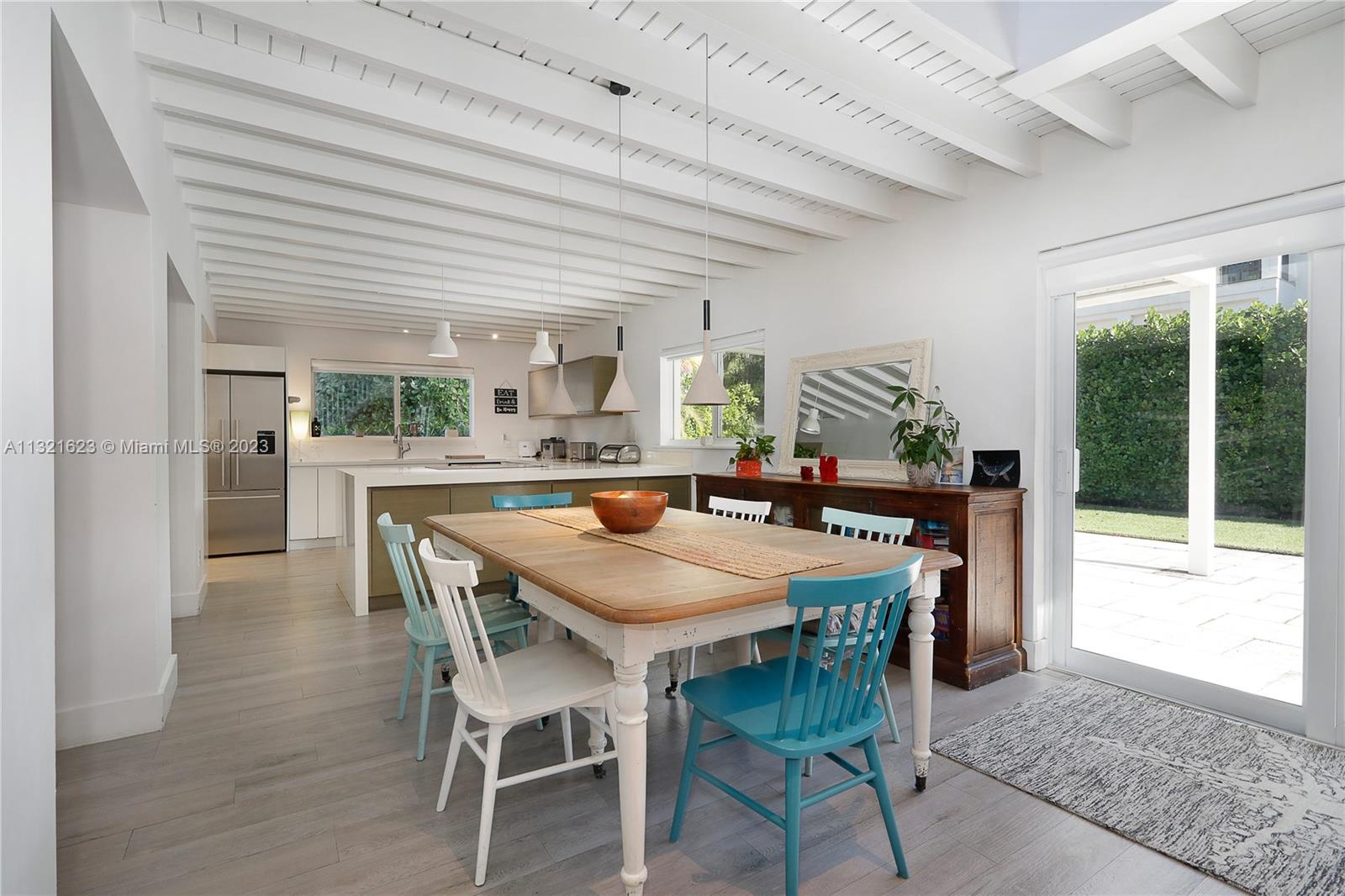 425 Glenridge Road Key Biscayne, FL 33149 - Photo 9 of 37 a dining room with furniture and a floor to ceiling window