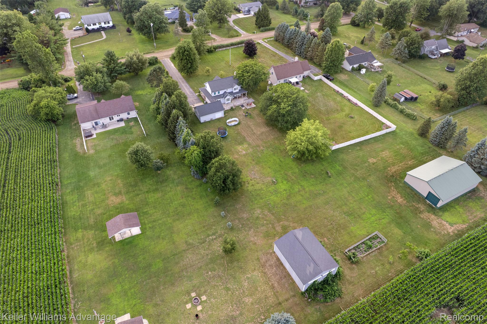 22627 Otter Road New Boston, MI 48164 - Photo 47 of 52 Expansive property featuring a large outbuilding with a green roof, a separate shed, and a fenced yard area