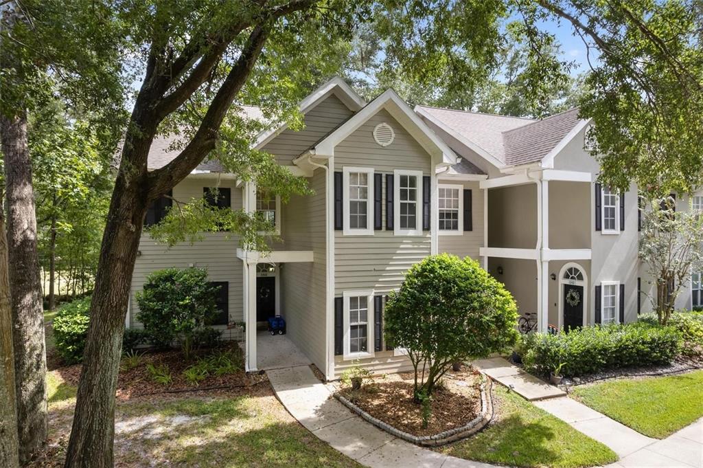 10000 Southwest 52nd Avenue, Unit EE 183 Gainesville, FL 32608 - Photo 1 of 16 a front view of a house with a yard