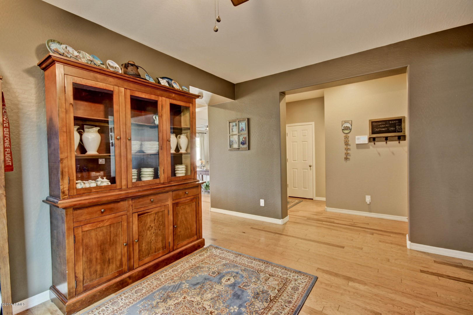 2280 North Alsap Road Buckeye, AZ 85396 - Photo 10 of 65 a view of a hallway with wooden floor and cabinet