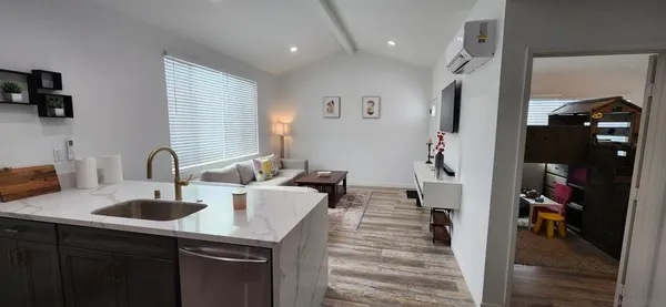 a kitchen with kitchen island a sink appliances and cabinets