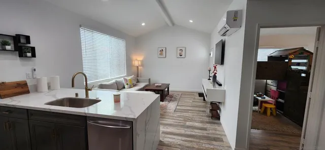 a kitchen with kitchen island a sink appliances and cabinets