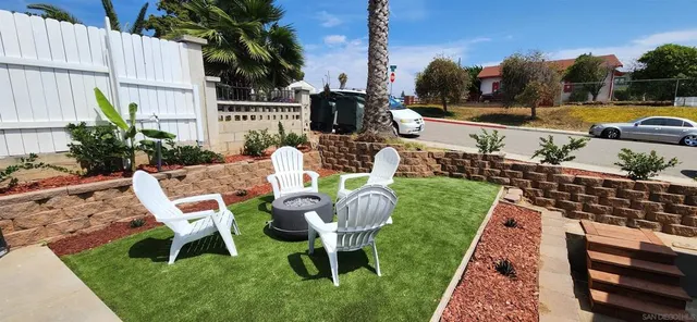 a view of a chairs and table in backyard of the house