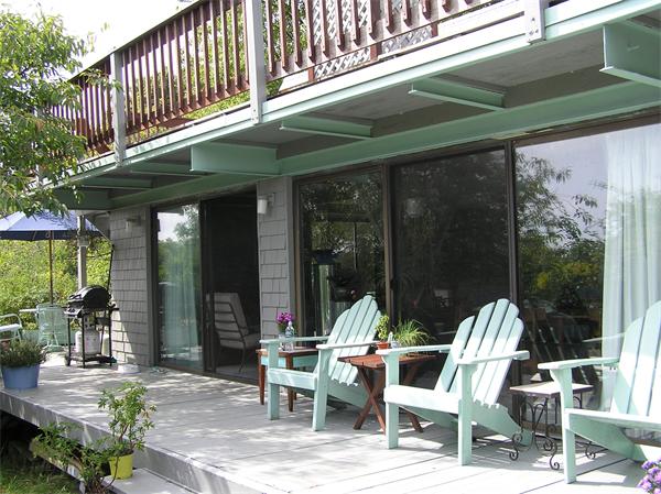 a view of a two chairs in the balcony