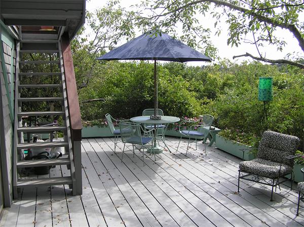 10 Brace Cove Gloucester, MA 01930 - Photo 4 of 13 a view of a chairs and table in the patio and a garden view