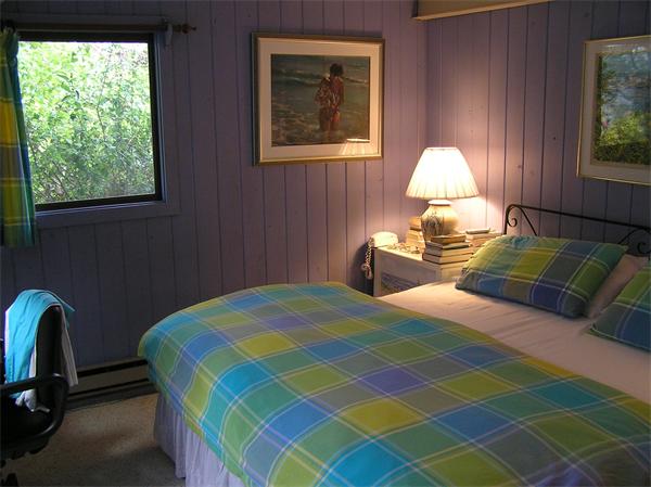 10 Brace Cove Gloucester, MA 01930 - Photo 8 of 13 a bedroom with a bed and a lamp next to a window