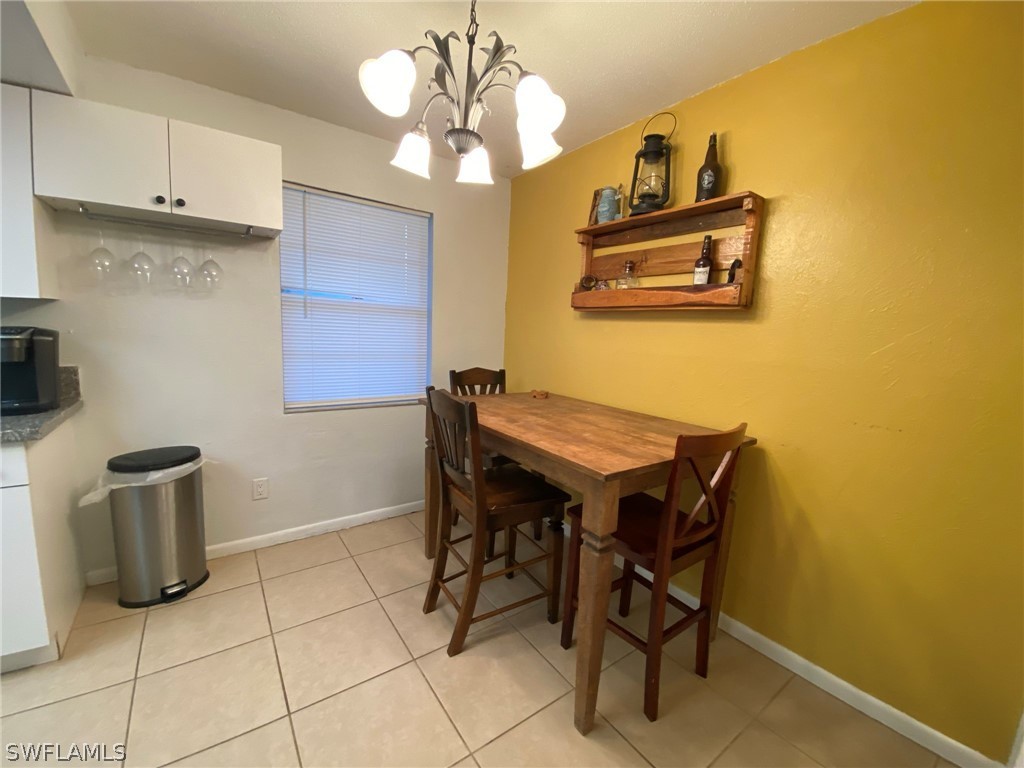 19157 Coconut Road Fort Myers, FL 33967 - Photo 11 of 26 a view of a dining room with furniture and chandelier