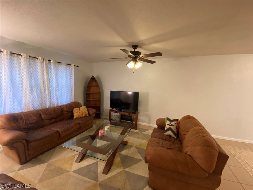19157 Coconut Road Fort Myers, FL 33967 - Photo 12 of 26 a living room with furniture and a flat screen tv