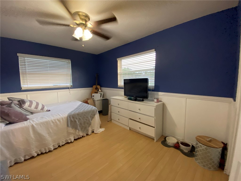 19157 Coconut Road Fort Myers, FL 33967 - Photo 15 of 26 a bedroom with a bed and a flat screen tv