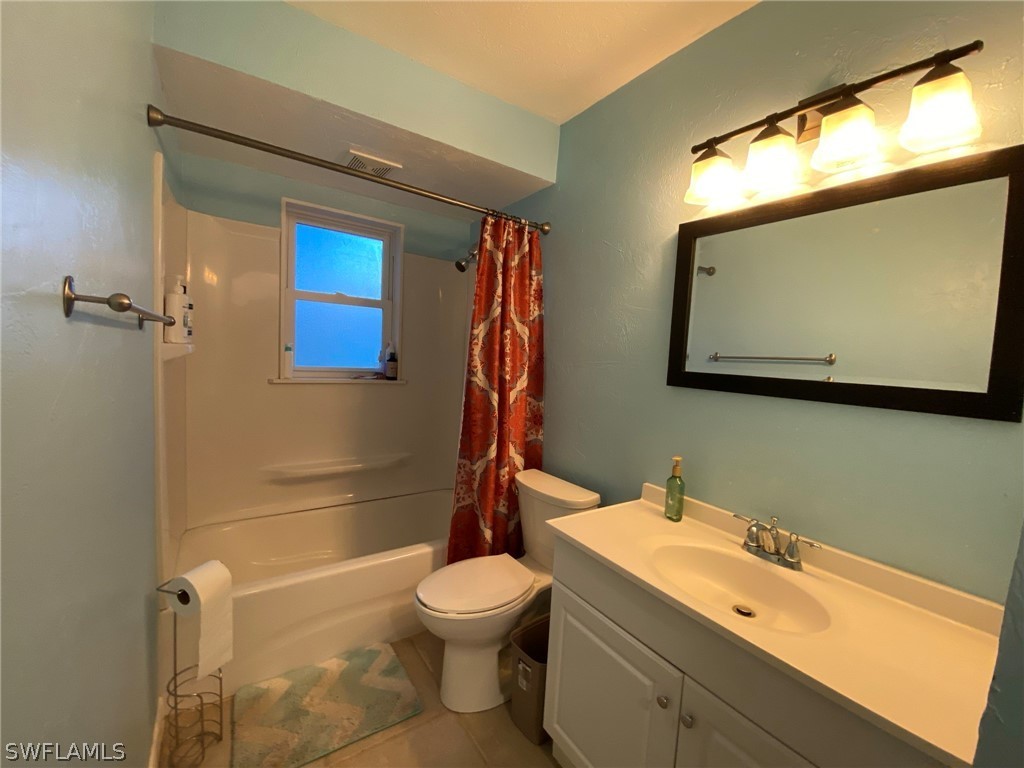 19157 Coconut Road Fort Myers, FL 33967 - Photo 16 of 26 a bathroom with a sink a toilet and shower