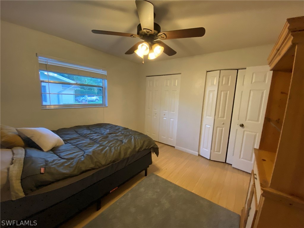 19157 Coconut Road Fort Myers, FL 33967 - Photo 18 of 26 a bedroom with a bed and a chandelier