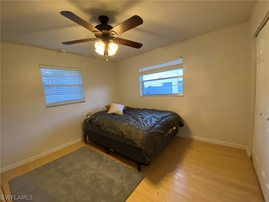 19157 Coconut Road Fort Myers, FL 33967 - Photo 19 of 26 a bedroom with a bed and a ceiling fan