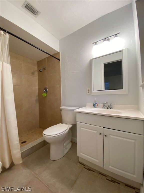 19157 Coconut Road Fort Myers, FL 33967 - Photo 20 of 26 a bathroom with a toilet sink and mirror