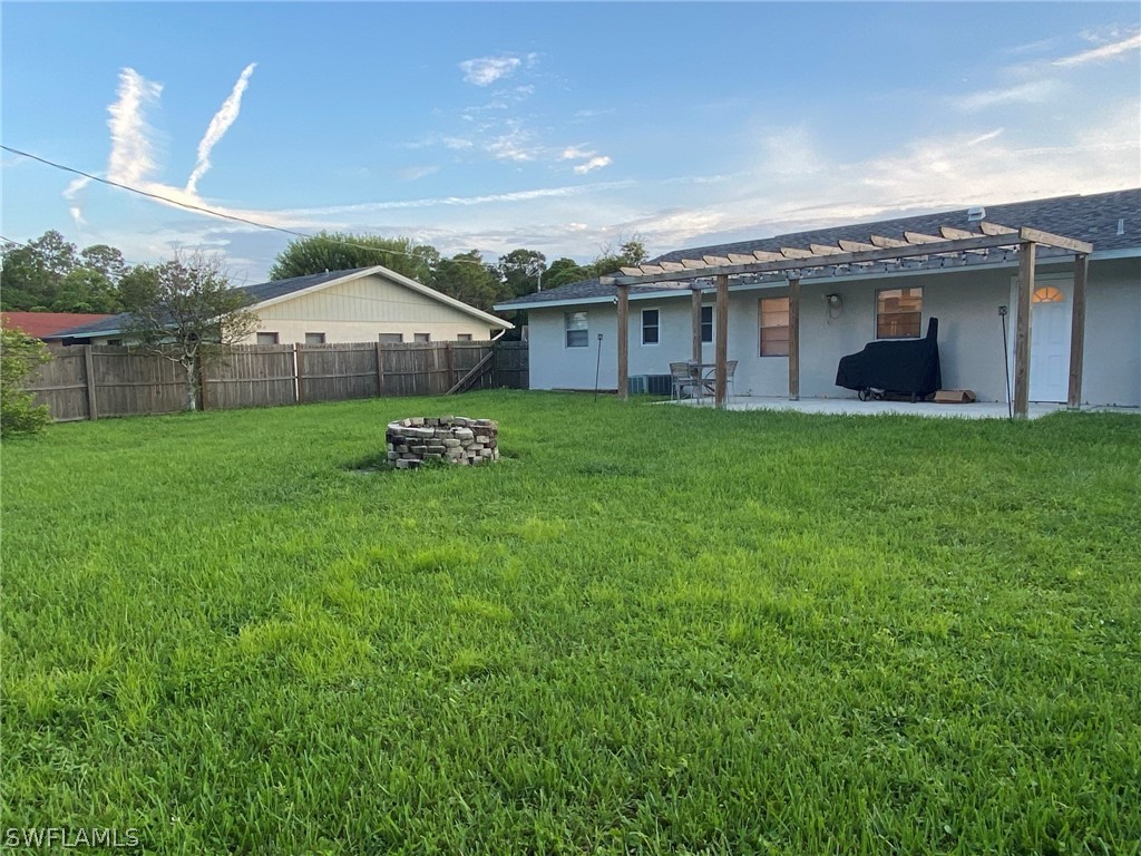 19157 Coconut Road Fort Myers, FL 33967 - Photo 4 of 26 a front view of a house with a garden