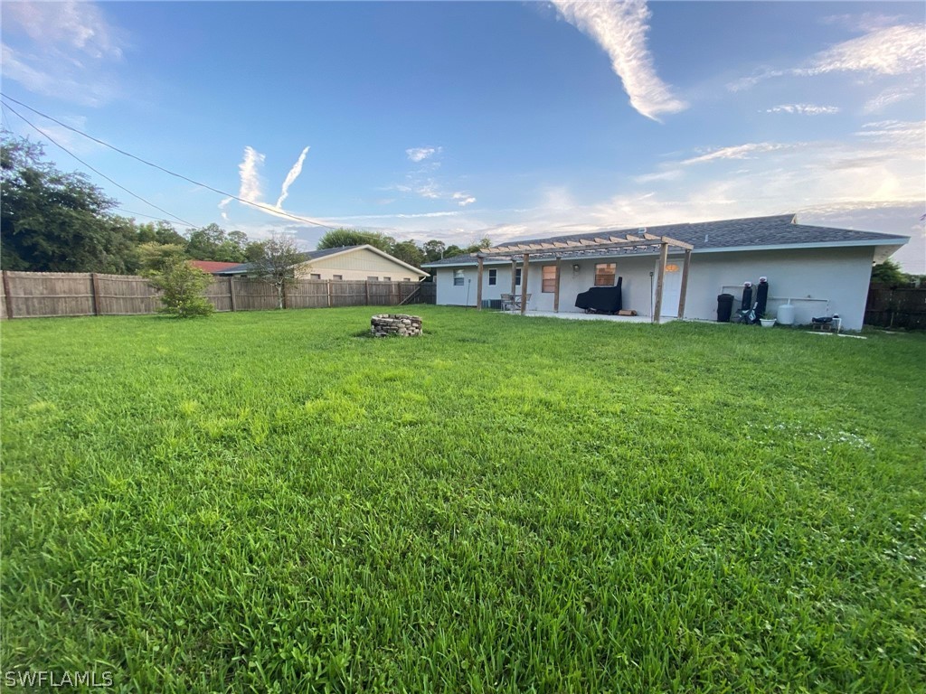 19157 Coconut Road Fort Myers, FL 33967 - Photo 5 of 26 a view of a big yard next to a house