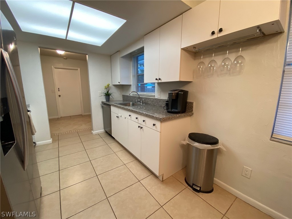 19157 Coconut Road Fort Myers, FL 33967 - Photo 8 of 26 a kitchen with stainless steel appliances granite countertop a sink and a refrigerator