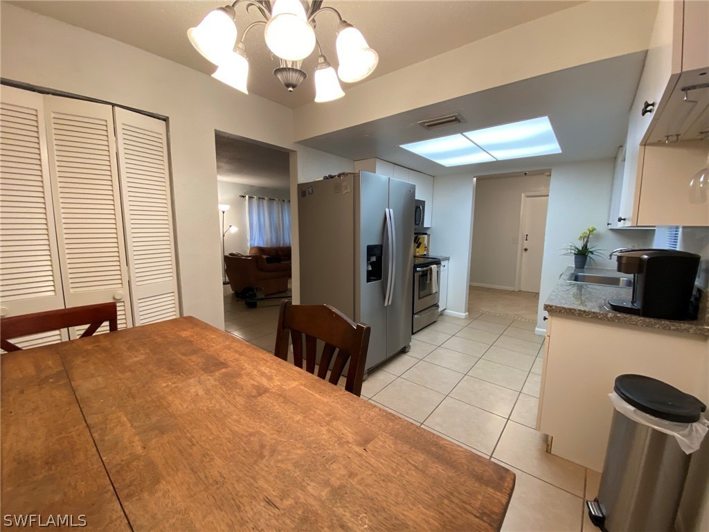 19157 Coconut Road Fort Myers, FL 33967 - Photo 10 of 26 a bedroom with a bed and a television