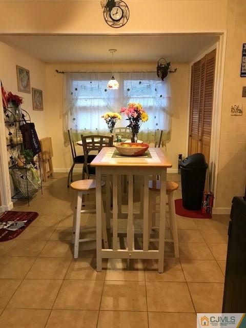 35 Caldwell Road Edison, NJ 08817 - Photo 5 of 16 a dining room with furniture and a gym machine