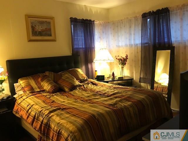 35 Caldwell Road Edison, NJ 08817 - Photo 9 of 16 a bed sitting in a bedroom next to a window