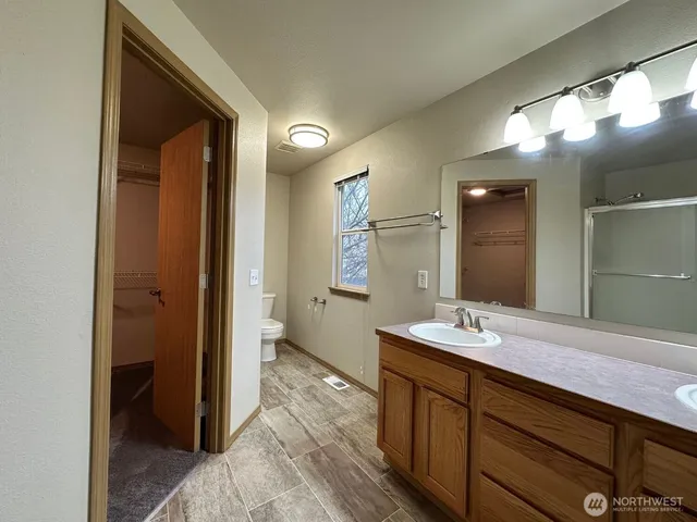 a spacious bathroom with a double vanity sink and a mirror
