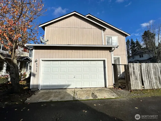a front view of a house with a garage