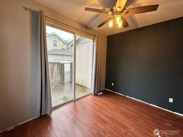 an empty room with wooden floor and door