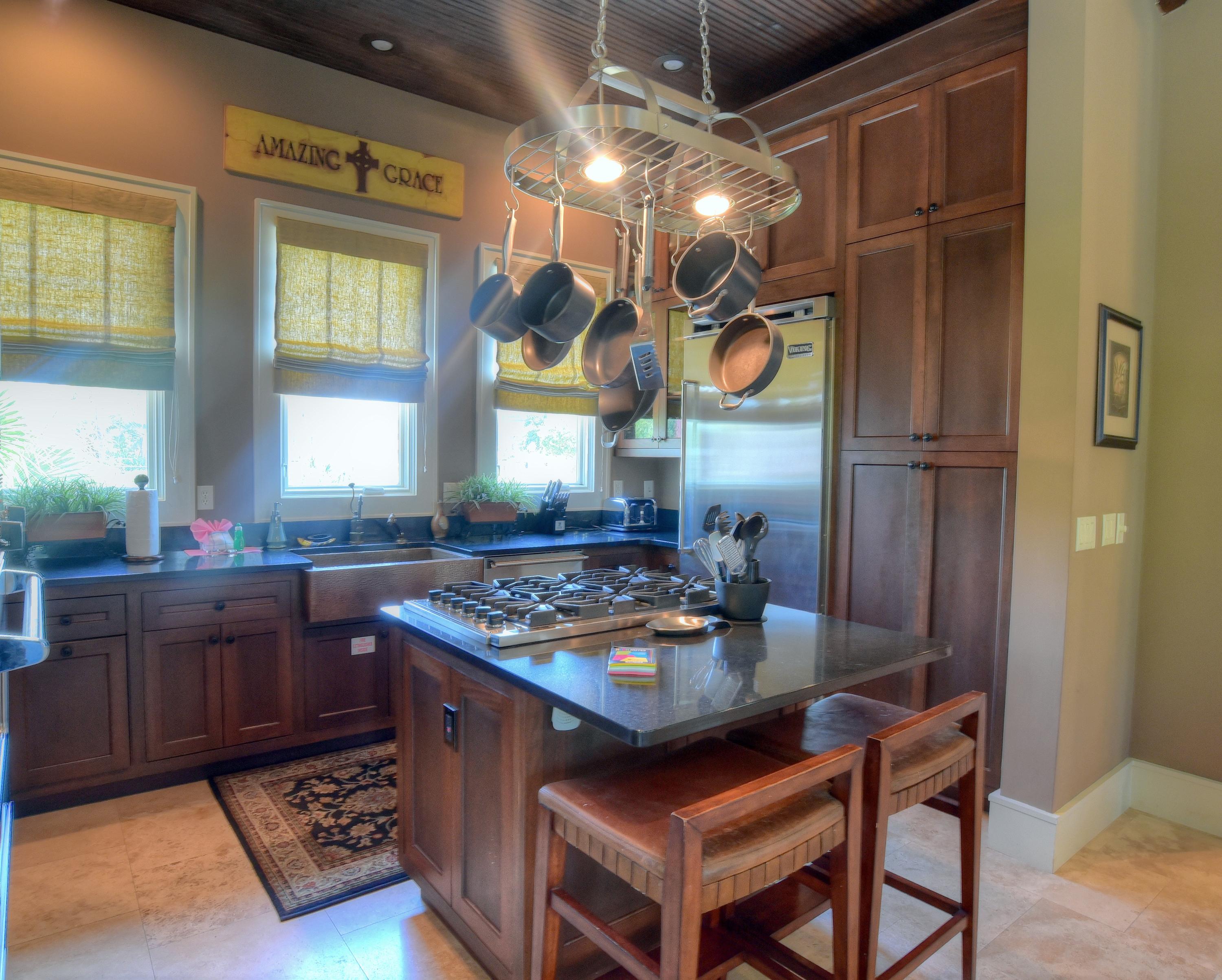 40 Rue Caribe Miramar Beach, FL 32550 - Photo 13 of 64 a kitchen with stainless steel appliances granite countertop a stove a refrigerator and a wooden cabinets