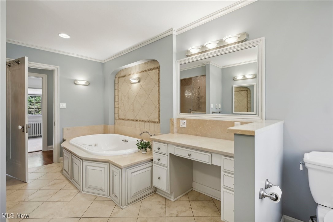 681 Merriman Road Akron, OH 44303 - Photo 19 of 43 The lux ensuite bath features heated tile in the shower, a deep tub for relaxing, two sinks, and plenty of storage.