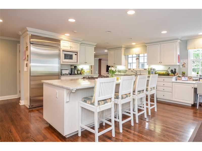 16 Willow Road Riverside, CT 06878 - Photo 11 of 24 a kitchen with stainless steel appliances kitchen island granite countertop a refrigerator and wooden cabinets