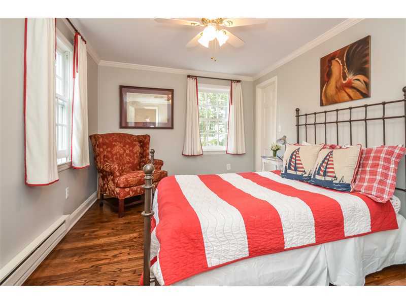 16 Willow Road Riverside, CT 06878 - Photo 18 of 24 a bedroom with a bed and wooden floor