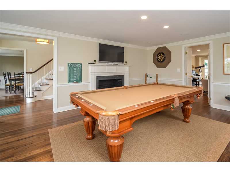 16 Willow Road Riverside, CT 06878 - Photo 9 of 24 a living room with a table chairs and a fireplace