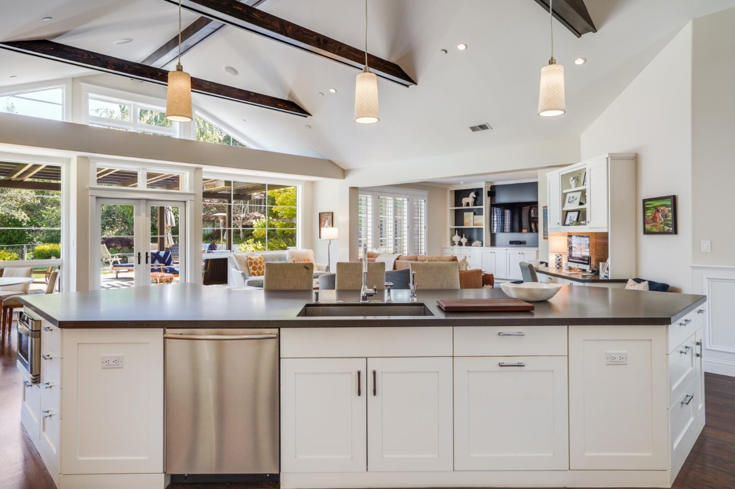 2533 Hayward Drive Burlingame, CA 94010 - Photo 11 of 47 a kitchen with kitchen island granite countertop a sink and white cabinets