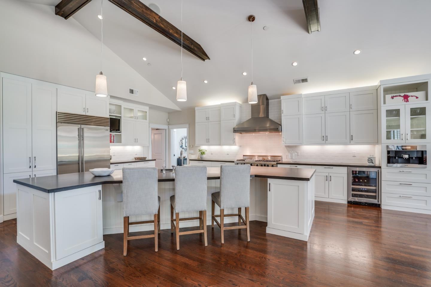 2533 Hayward Drive Burlingame, CA 94010 - Photo 12 of 47 a kitchen with stainless steel appliances kitchen island granite countertop a table chairs sink and cabinets