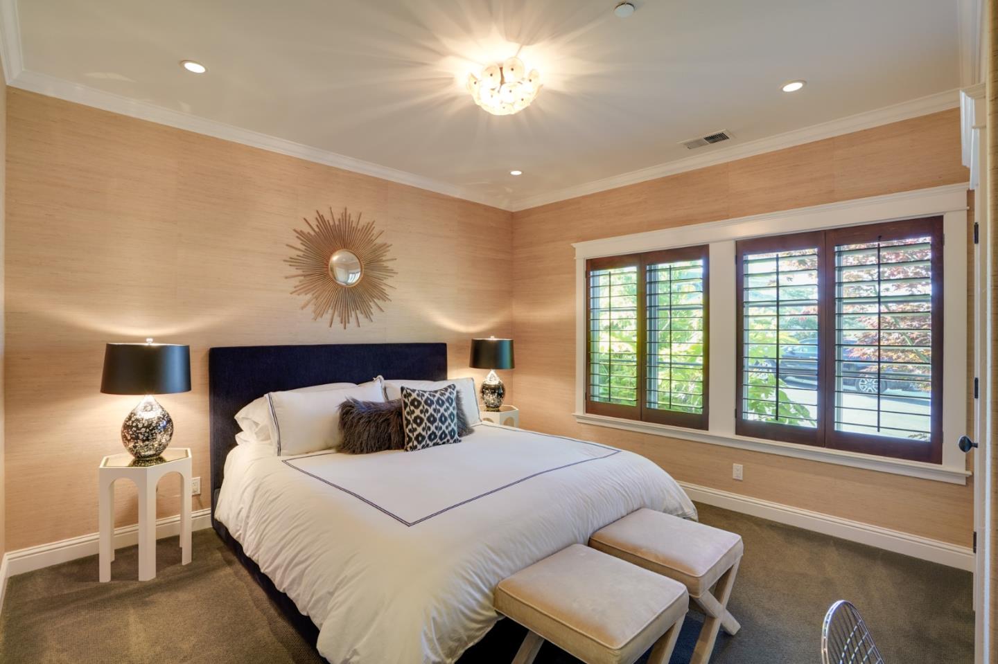 2533 Hayward Drive Burlingame, CA 94010 - Photo 28 of 47 a bedroom with a large bed and a chandelier