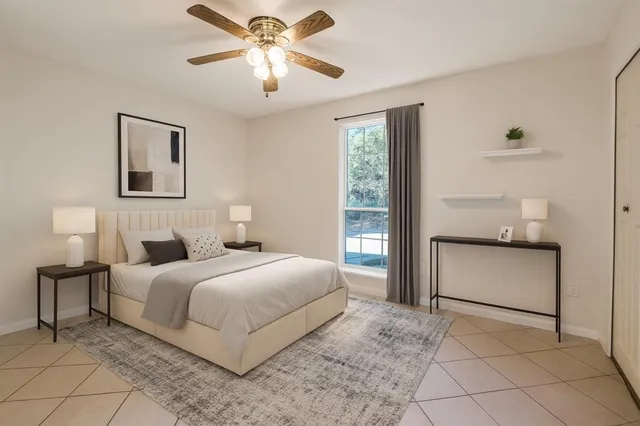 a bedroom with a large bed and a chandelier