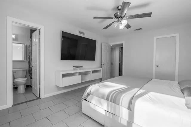 a bedroom with a bed and a flat screen tv