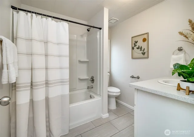 a bathroom with a sink mirror and vanity
