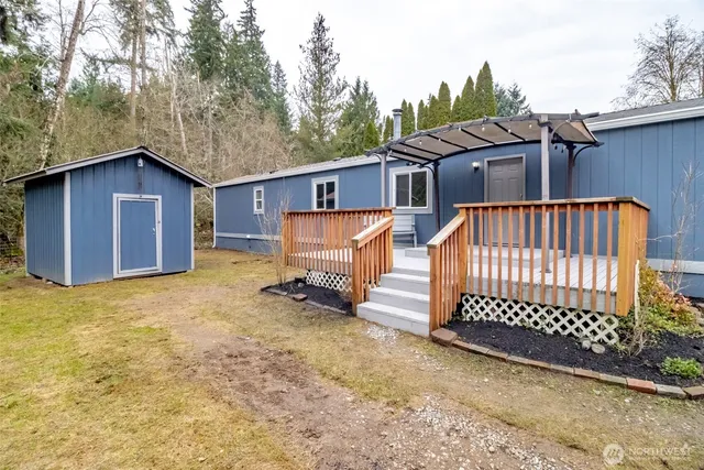 a view of a house with a wooden fence