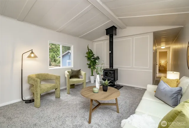 a living room with lots of furniture and a large window