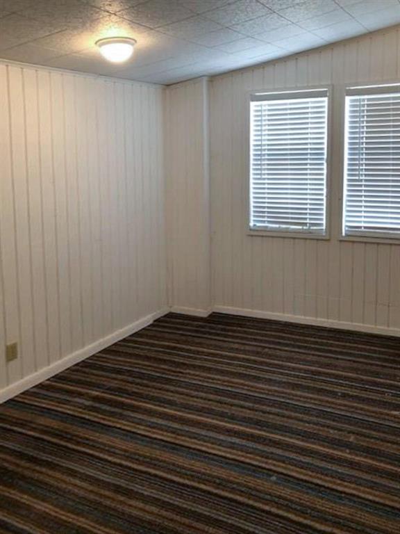 602 West 3rd Street Justin, TX 76247 - Photo 15 of 22 Interior room featuring white vertical paneling and a textured ceiling