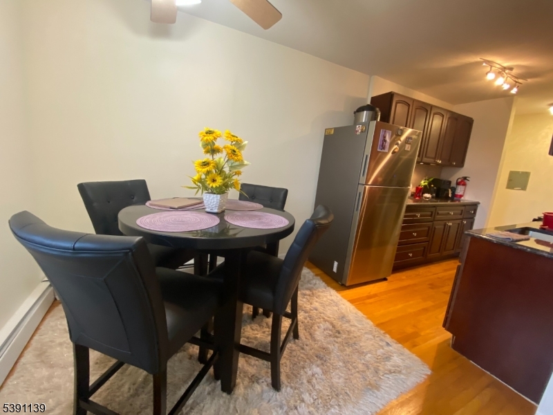 824 Main Street, Unit J Belleville, NJ 07109 - Photo 16 of 24 a view of a dining room with furniture and wooden floor