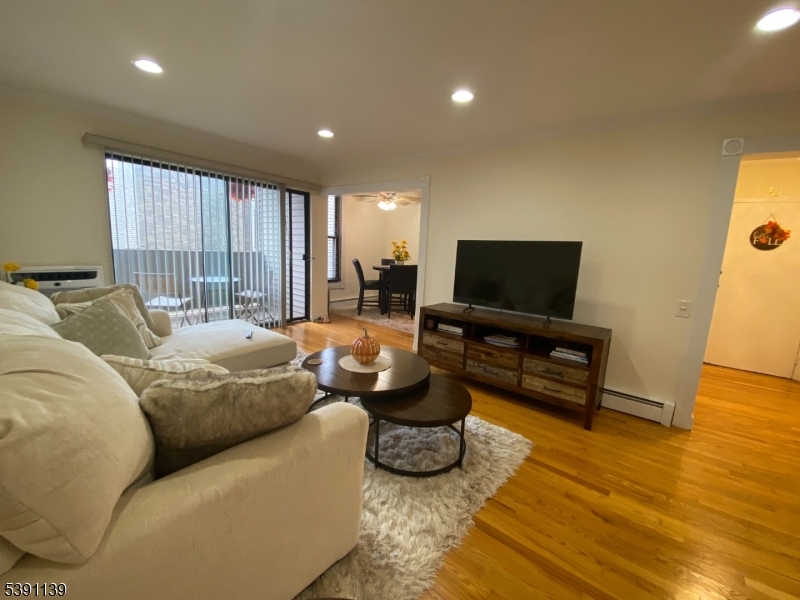 824 Main Street, Unit J Belleville, NJ 07109 - Photo 17 of 24 a living room with furniture and a flat screen tv