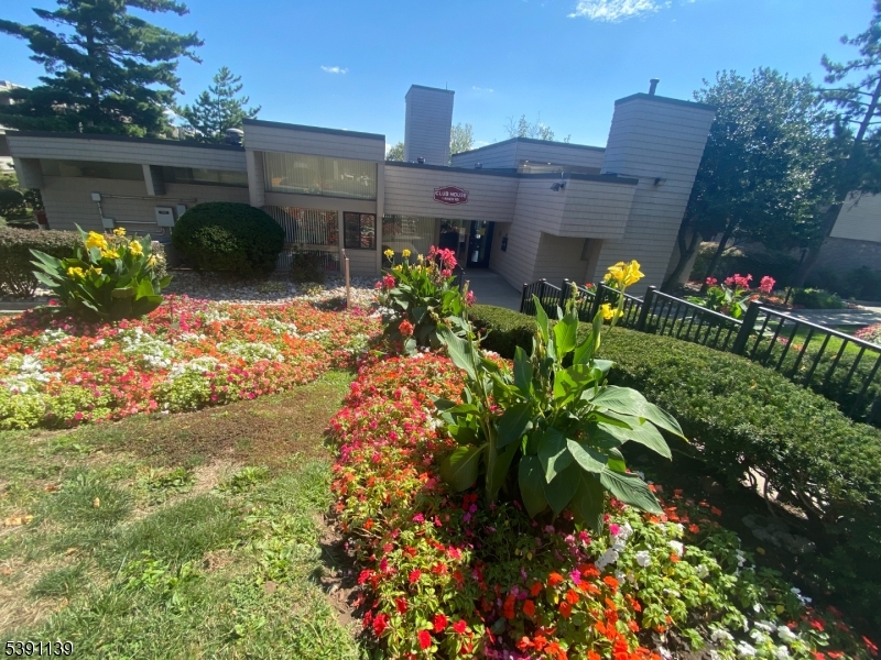 824 Main Street, Unit J Belleville, NJ 07109 - Photo 18 of 24 a front view of a house with a yard and a garden